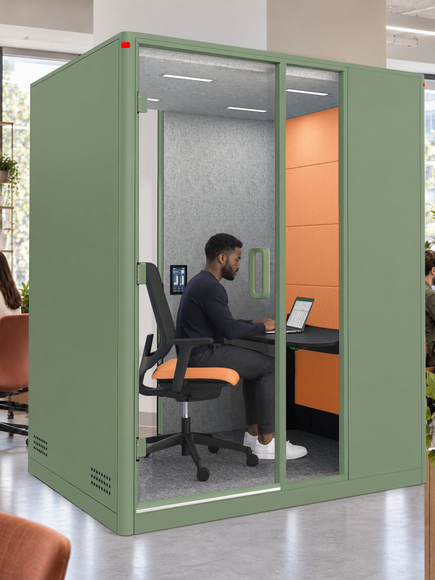 A Calma Focus pod in a coworking space, a man working at the desk inside